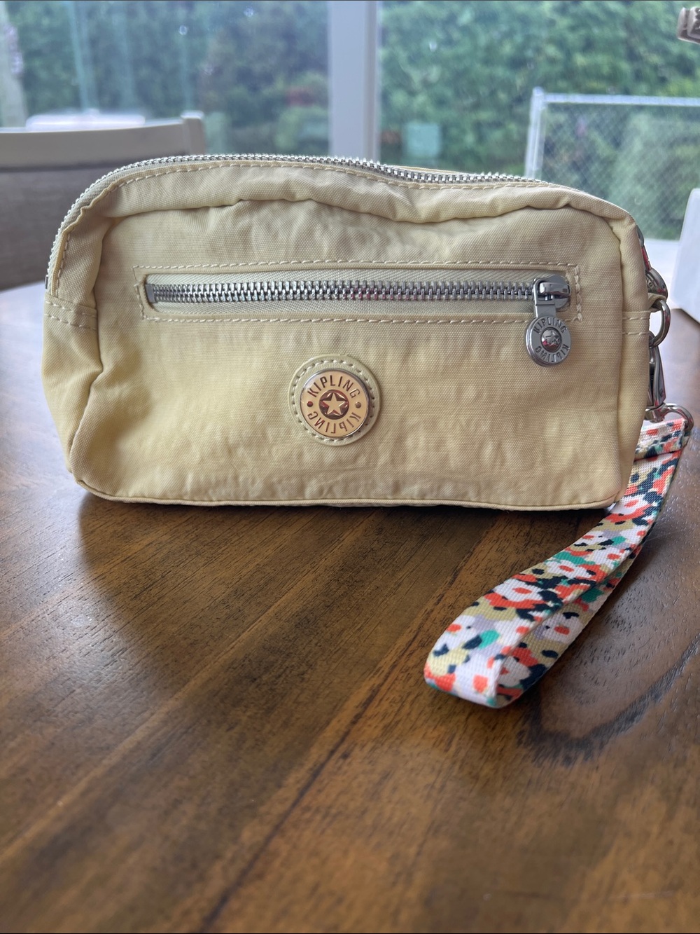 Kipling Pale Yellow Wristlet with Floral Patterned Wrist Strap